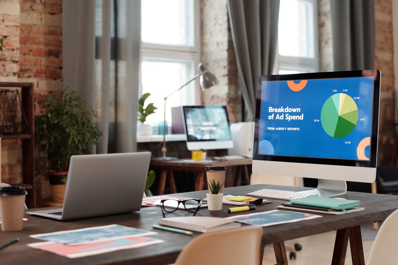 A contemporary office setting with computers, charts, and office supplies, creating a productive atmosphere.